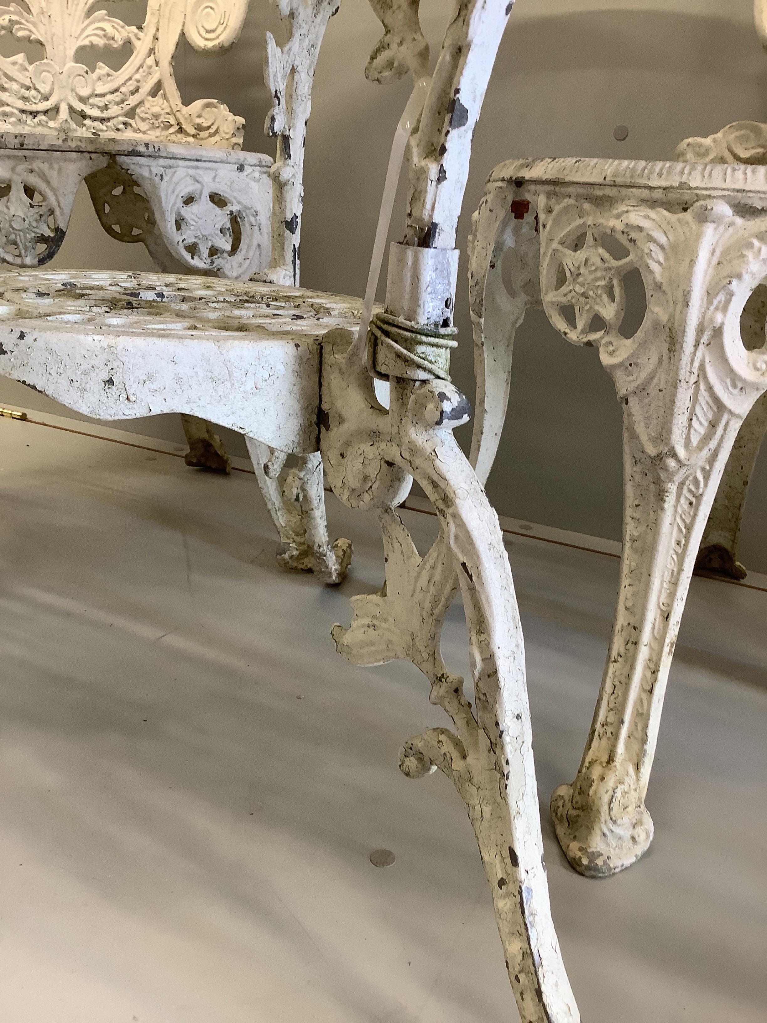 A Victorian style painted cast aluminium circular garden table, diameter 106cm, height 70cm, together with four matching chairs (table, one leg a.f.)
